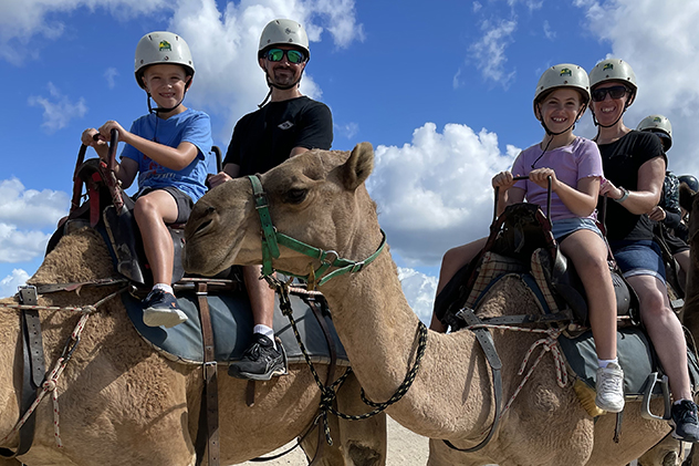 People riding camels at Birubi Beach