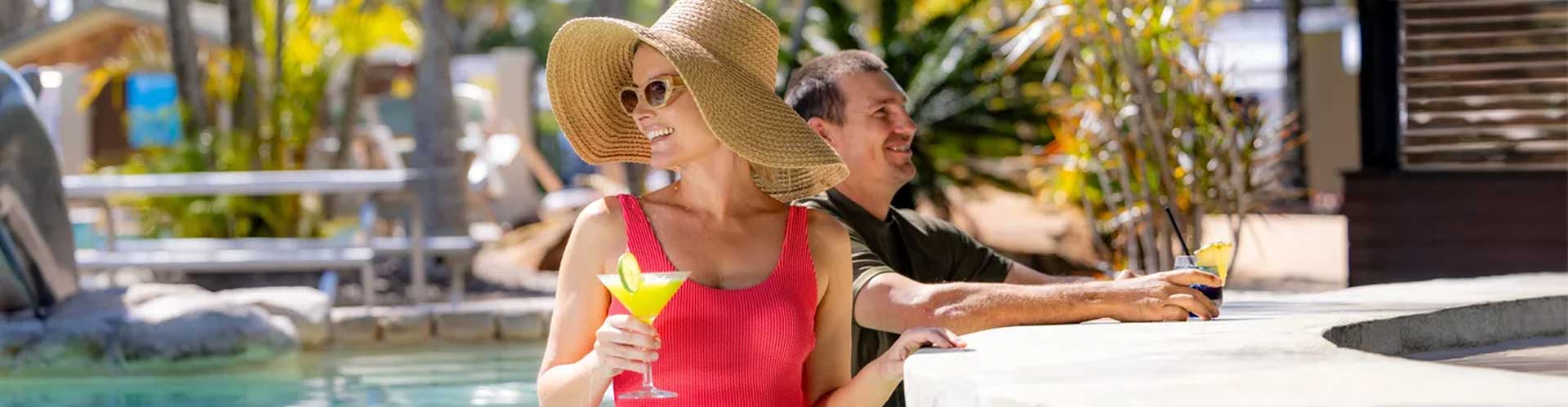 A woman in red swimsuit at a pool bar