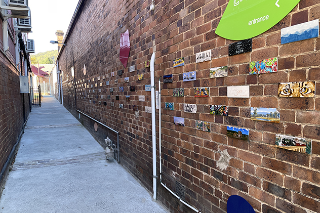 Paintings on a brick wall in a laneway