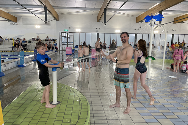 A boy squirting his dad with water at Bay Pavilions