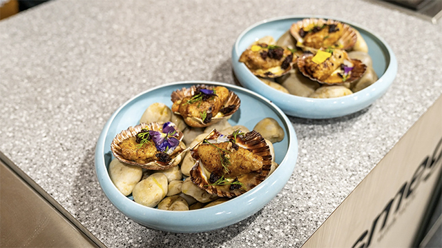 Two blue bowls with oysters in them
