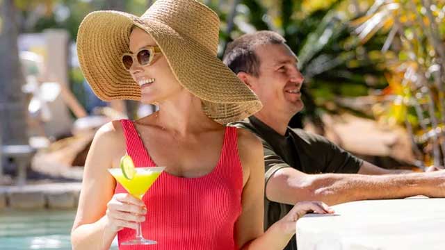 A woman in red swimsuit at a pool bar 