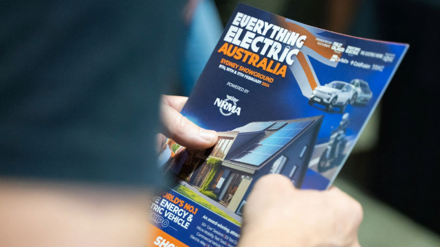 Person holding a copy of the Everything Electric Australia magazine.