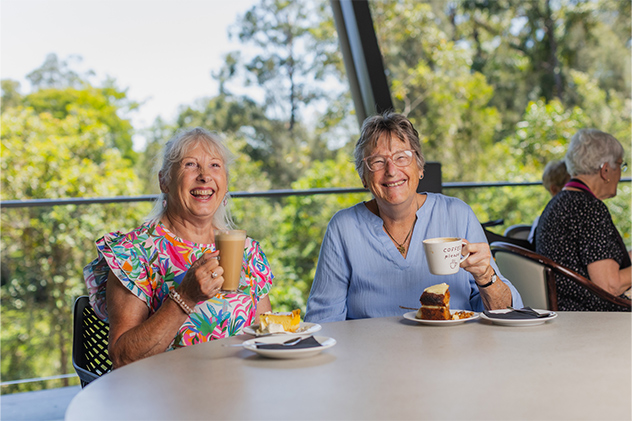 Two women enjoying coffee at Rumours Café at Buderim Gardens