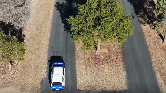an NRMA car driving along a country road