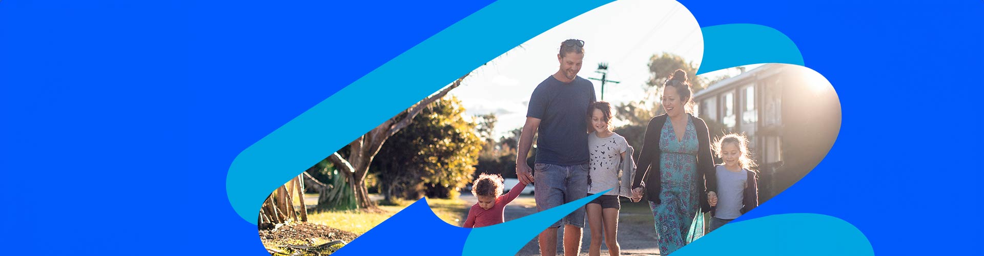 Family of five walk on path near buildings surrounded by blue NRMA branded keyhole design