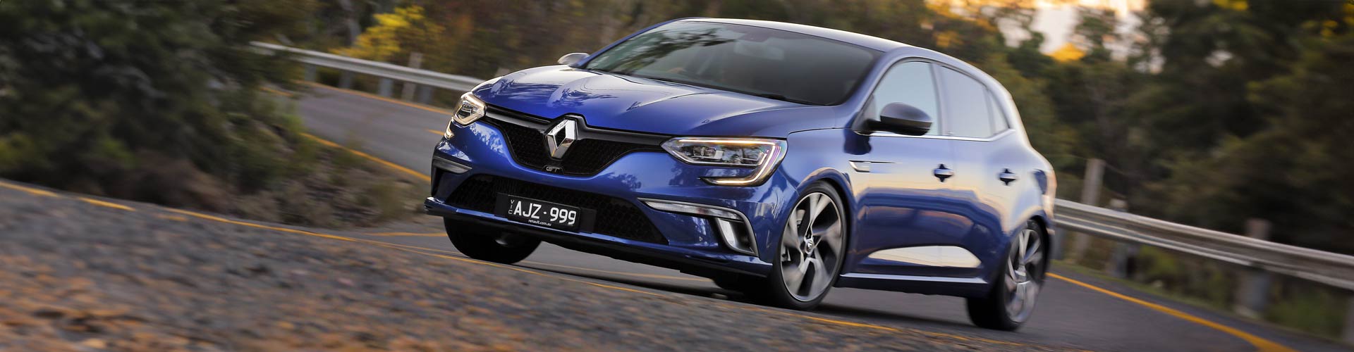 Blue 2016 Renault Megane GT driving on a curvy road