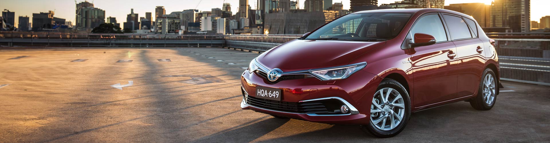 Red 2016 Toyota Corolla Hybrid in a carpark on a roof