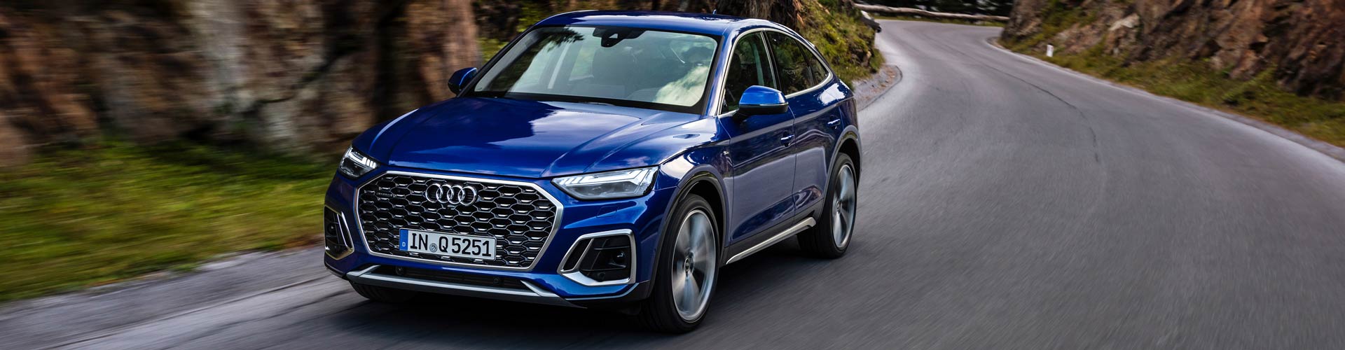 A 2022 Audi Q5 Sportback driving along a winding road A 2022 Audi Q5 Sportback driving along a winding road