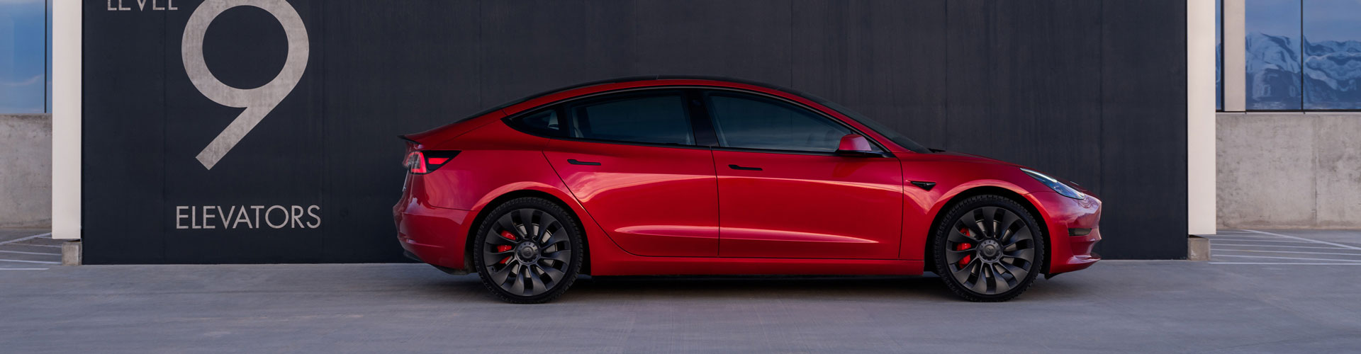 A red Tesla Model 3