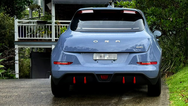 A grey car parked in a driveway