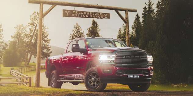 Oversized RAM 2500 ute parked under a country property sign