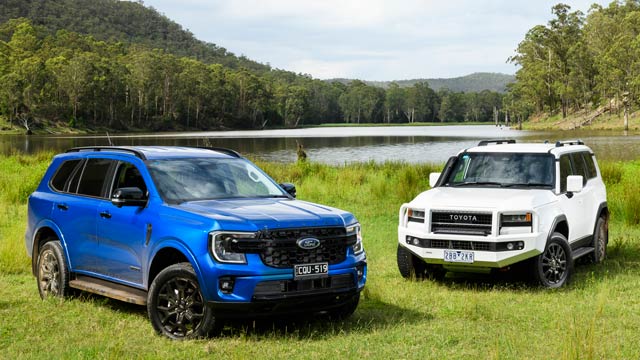 2025 Toyota Prado and Ford Everest parked in front of a lake