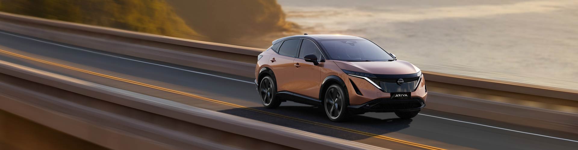 Copper Nissan Ariya driving on Seacliff bridge