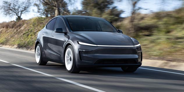 2026 Juniper Tesla Model Y driving on country road