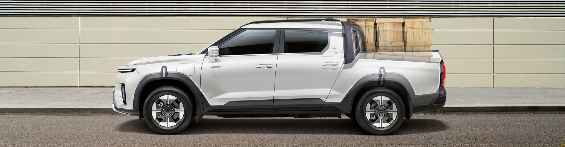 White Musso EV ute seen from the side