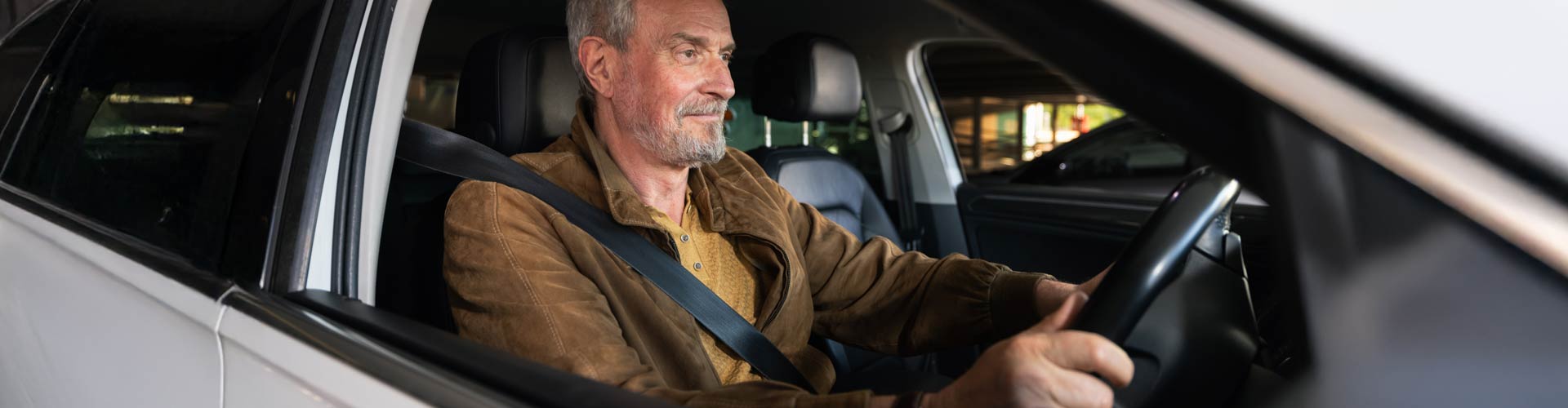 60+ man driving car at night