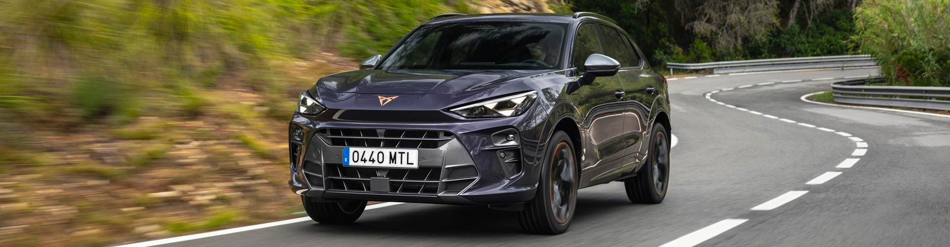 A Cupra Terramar SUV driving on a curved road