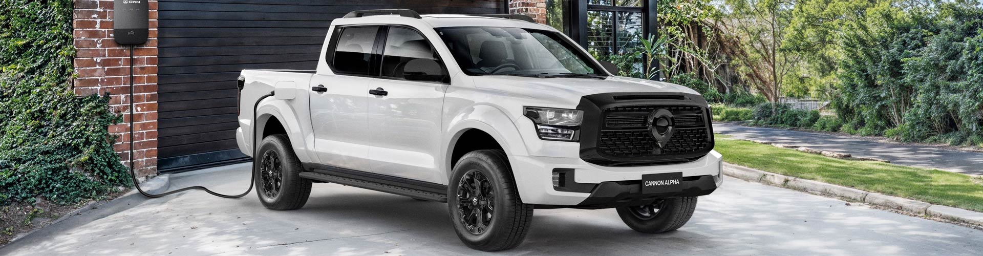 A white GWM Cannon Alpha plug-in hybrid parked in a driveway