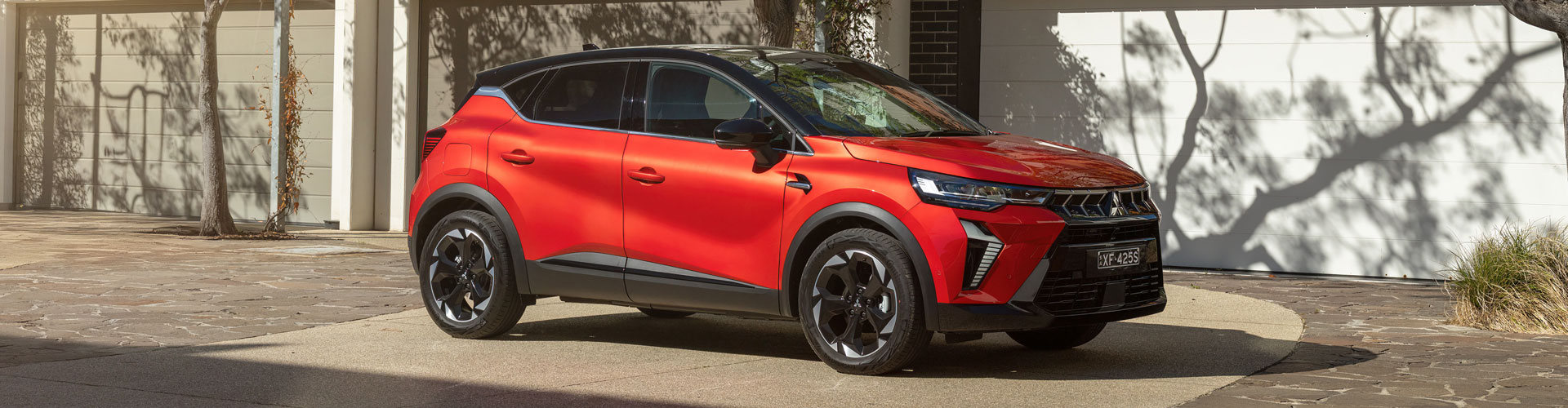 Side angle of a red 2025 Mitsubishi ASX