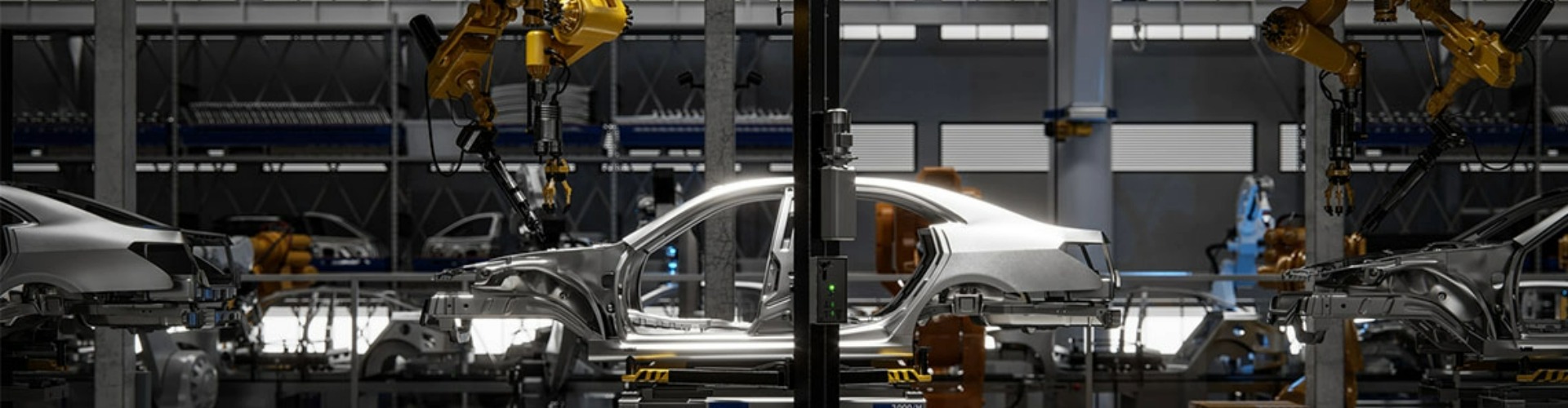 A silver car on the manufacturing assembly line being built by a yellow robotic arm.