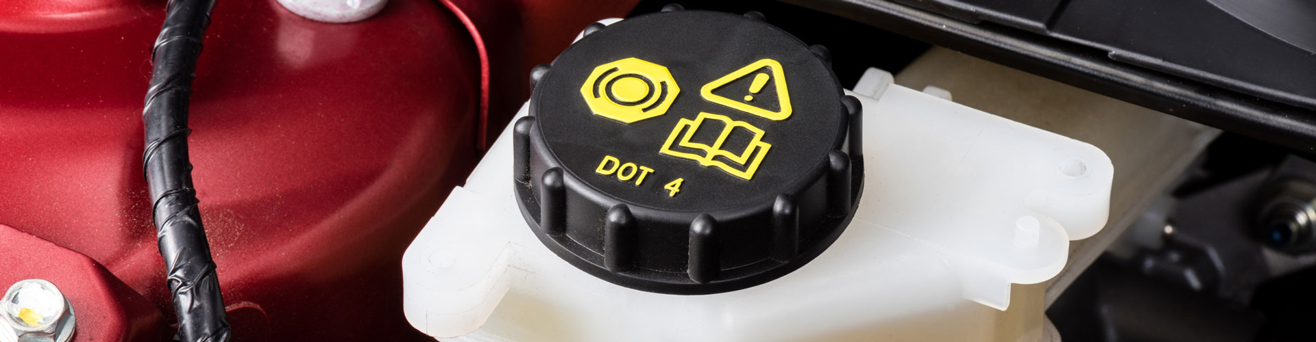 Brake fluid reservoir in an engine bay