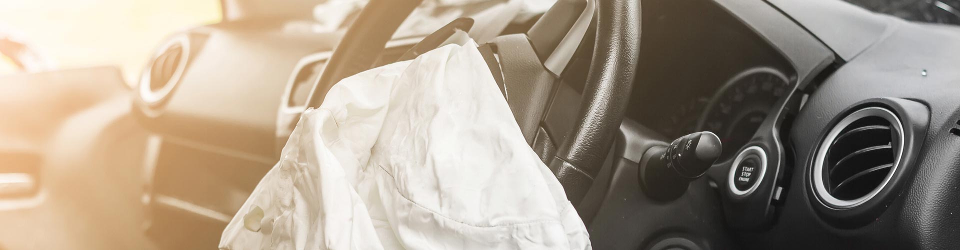 A deployed airbag on a steering wheel of a car