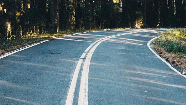 Curved road with double white lines in the centre