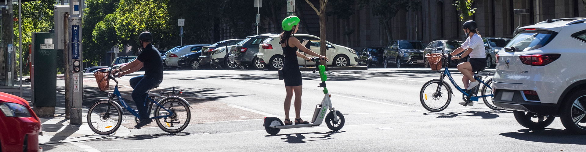Crossing an intersection on an e-scooter.