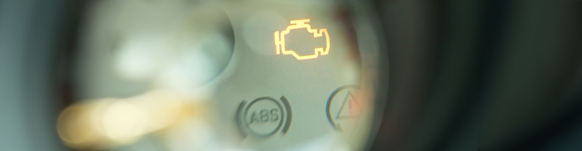 Bokeh image of engine light on car dashboard