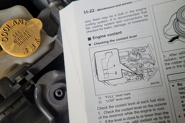Vehicle owner's manual showing how to check coolant