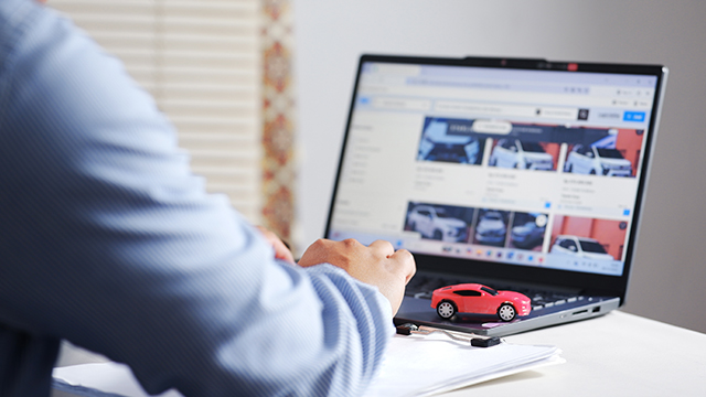 Man browsing for a car to buy online