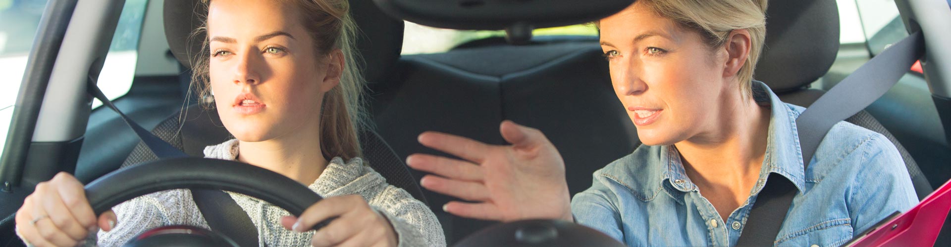 Young Girl Taking Driving Lessons with an Instructor