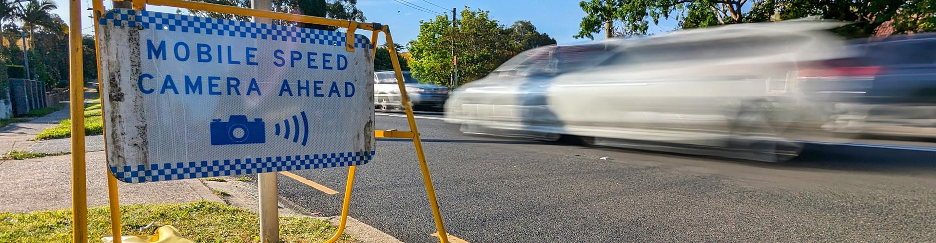 A car speeds past a mobile speed camera