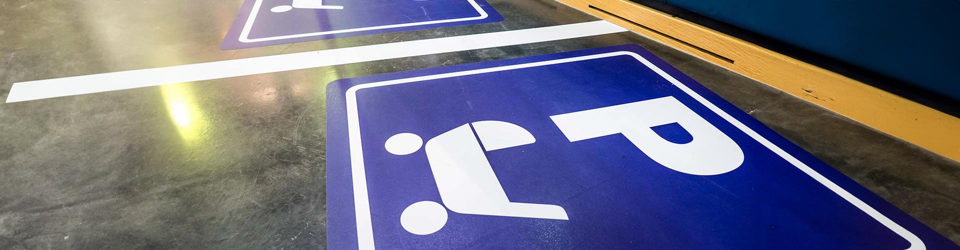 Image of parents with prams parking spaces with blue icons