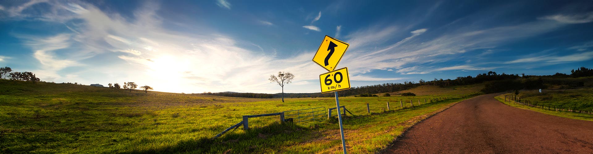 A 60km/h sign on a windy country road