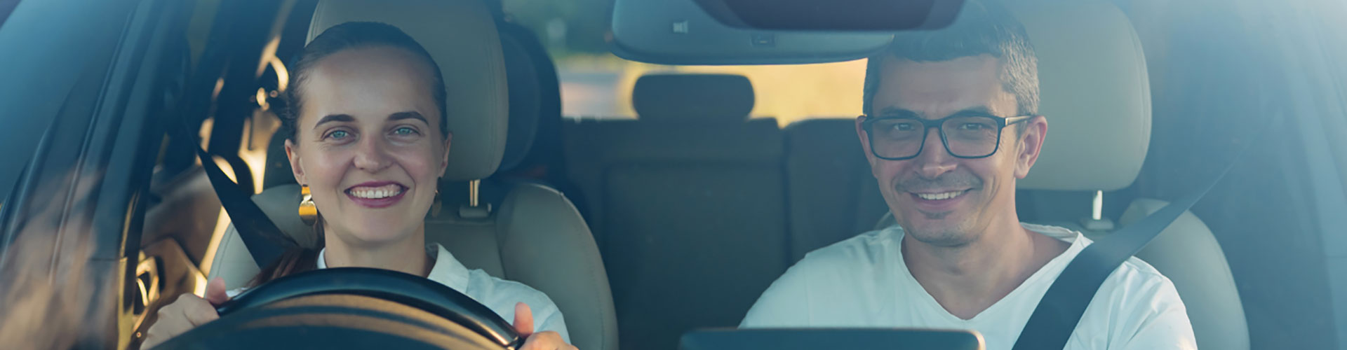 Couple sitting happily in new car