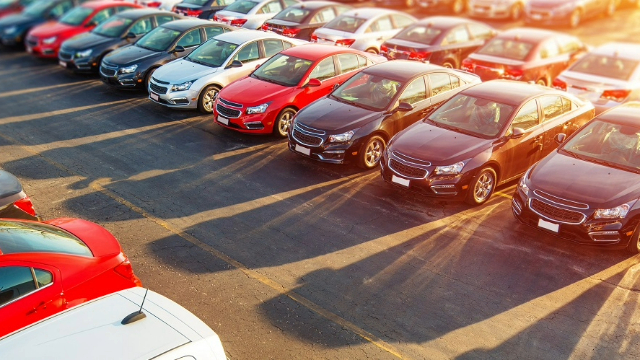 New cars lined up in a dealership yard