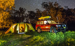 SUV parked next to a tent