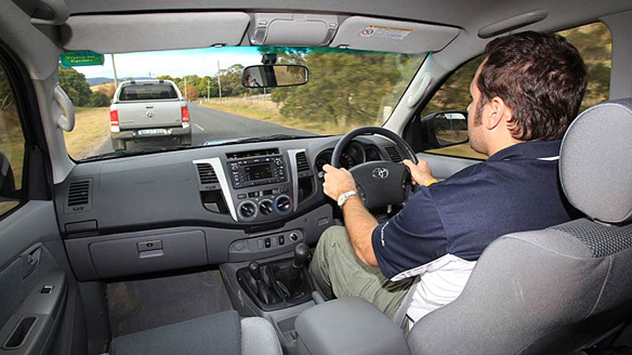 Man driving a blue 2011 Toyota Hilux