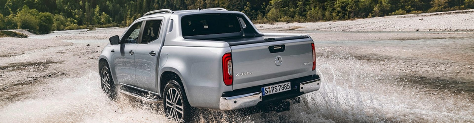 2018 Mercedes Benz X Class silver 2018 Mercedes-Benz X-class four door ute splashes through a shallow river bed