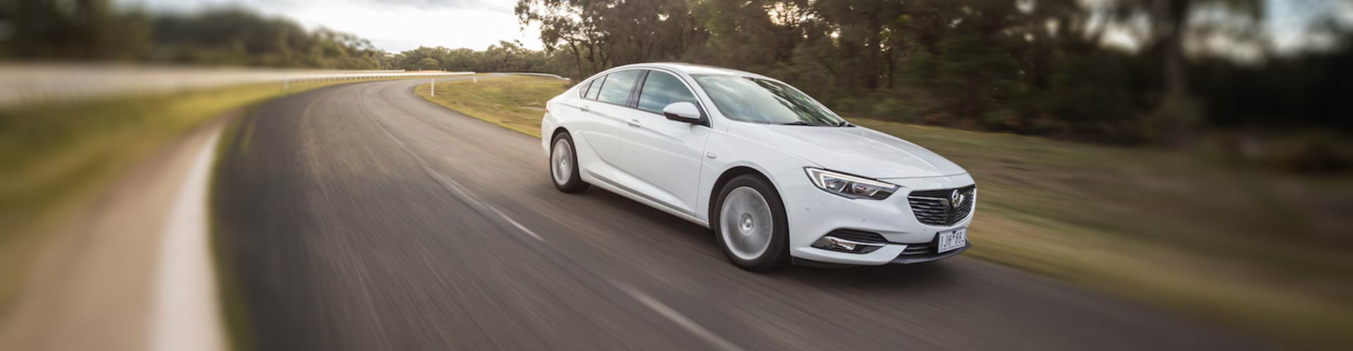 White 2018 Holden Commodore driving on a road with blurred background