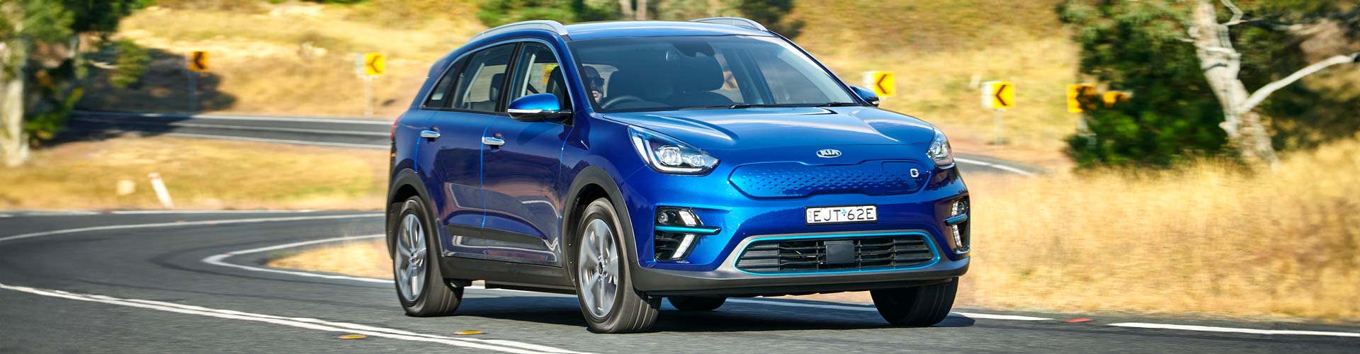 Blue 2021 Kia Niro EV driving on country road