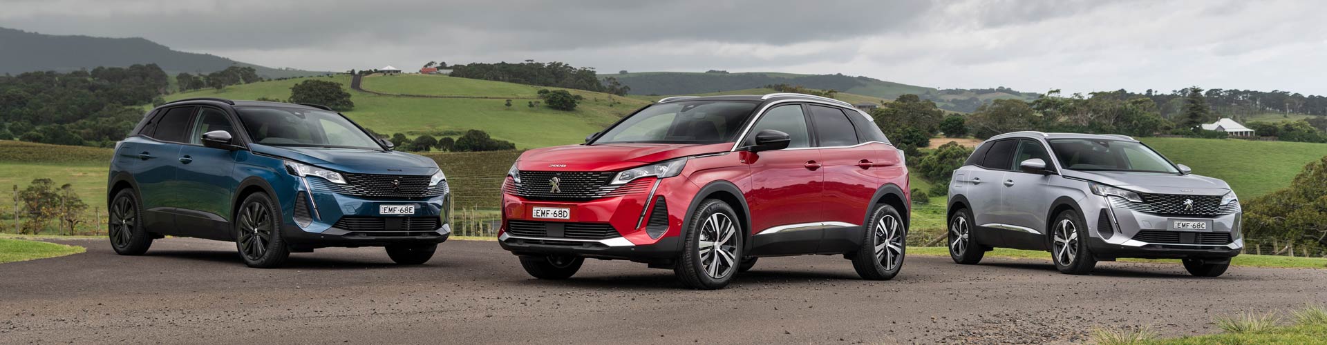 Three Peugeot 3008s parked in front of rolling hills