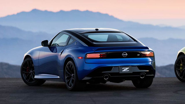 A blue 2023 Nissan Z parked at sunset overlooking mountains