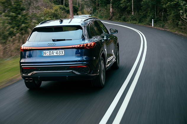 Rear view of 2025 Audi Q5 TDI driving  on the road