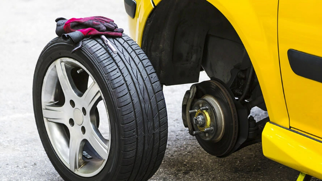Side view of a tyre being fitted to a car