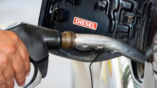 A diesel pump being inserted into a filler