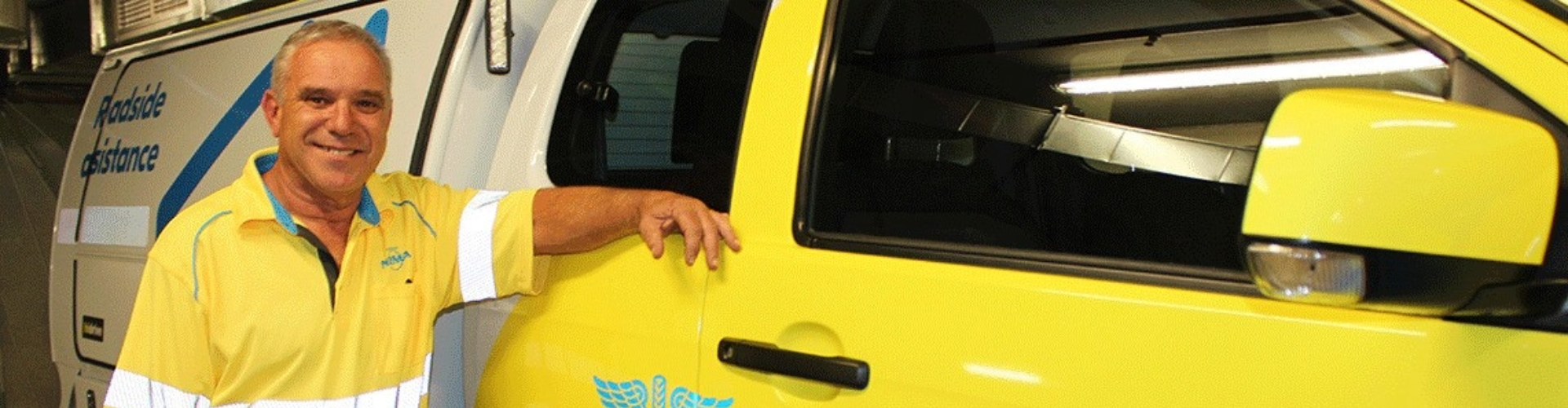 NRMA patrolman Brett Bishop leans against his patrol car.