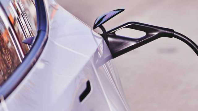 Side view of an EV charging cable plugged into a car. Photo: Michael Fortsch.